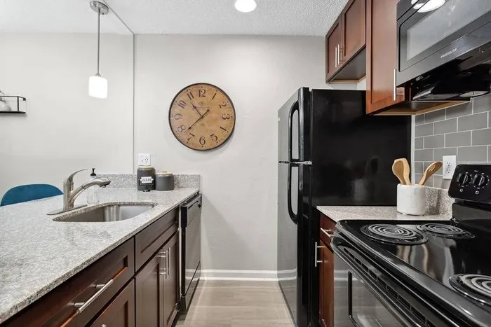 kitchen with black appliances and wood cabinets