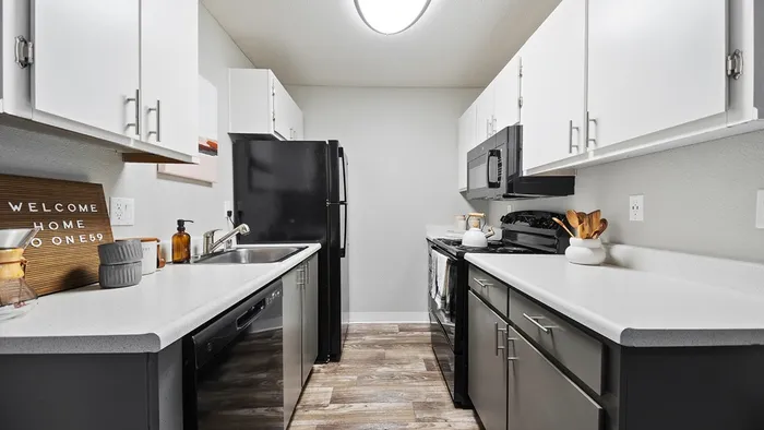 ReNew One59 Kitchen with black appliances and grey and white cabinets