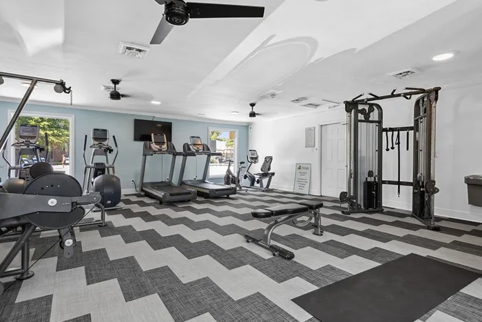 Renovated fitness center at ReNew Virginia Beach with cardio machines and weight machines