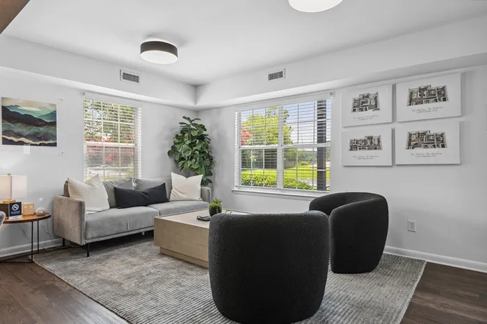 Leasing office sitting area at ReNew Virginia Beach with plush chairs and velvet couch