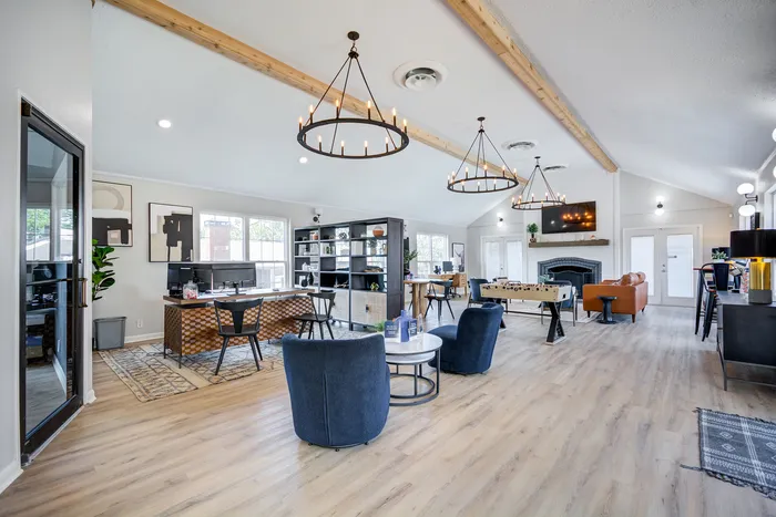 Bright and airy community lounge featuring modern decor, comfortable seating, and entertainment options.
