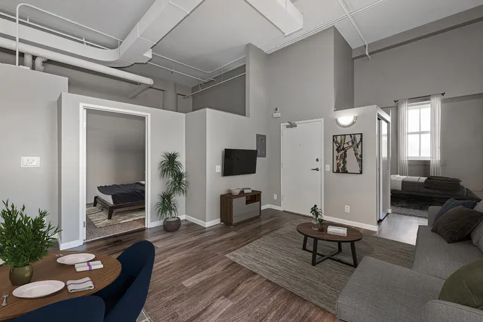 Modern apartment interior with open living area, cozy bedroom, and elegant decor.