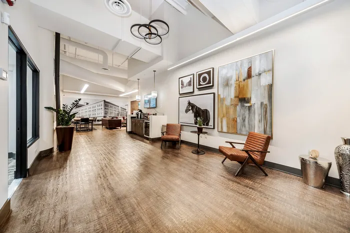 Sophisticated apartment lobby featuring modern decor, cozy seating, and stylish artwork.