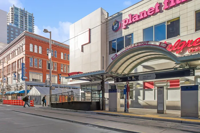Bustling street view with modern architecture and vibrant storefronts.