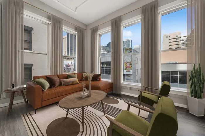 Contemporary living room with modern furniture, large windows, and a city view.