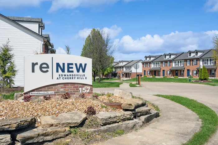Entrance view of ReNEW Edwardsville at Cherry Hill 2 with modern townhouses and landscaped surroundings.
