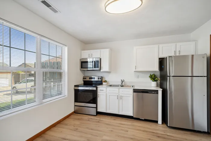 Bright, sleek kitchen with stainless steel appliances and modern cabinetry.
