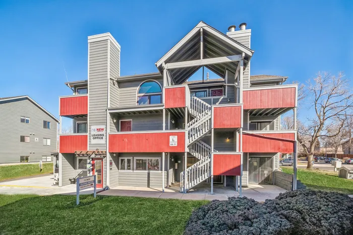 ReNew Foothills Modern apartment building with vibrant red accents and spacious balconies.
