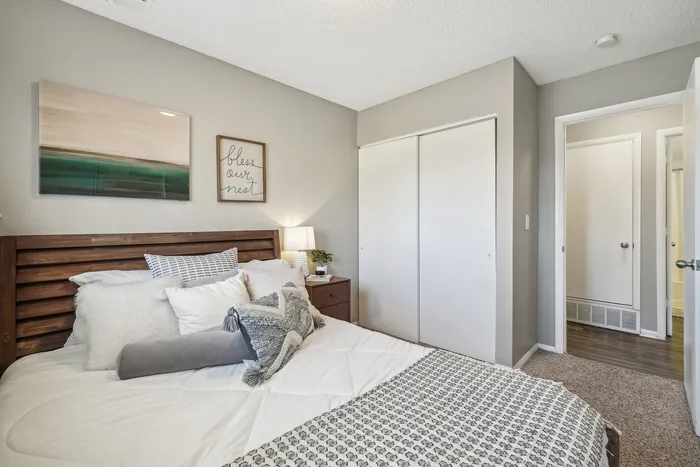 ReNew Foothills Inviting bedroom with modern decor, featuring a comfortable bed with plush pillows and stylish wall art.