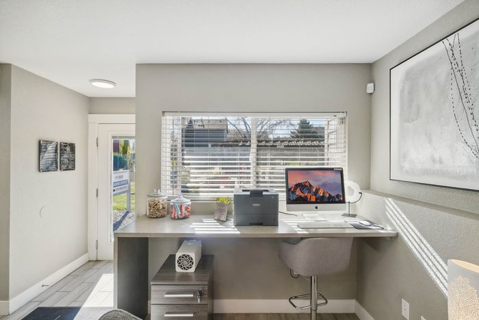 ReNew Foothills Chic home office with modern desk, computer, and scenic window view.