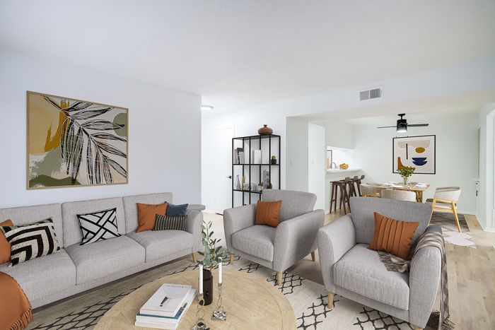 Chic open-concept living space with modern decor, plush seating, and vibrant artwork for a cozy and inviting atmosphere.