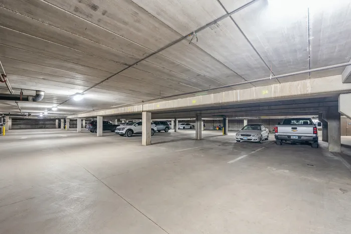 Spacious and well-lit underground parking garage with ample space for vehicles.