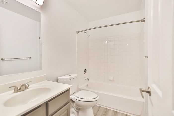 Modern bathroom at ReNew White Marsh with sleek fixtures, a spacious bathtub, and elegant tile accents.