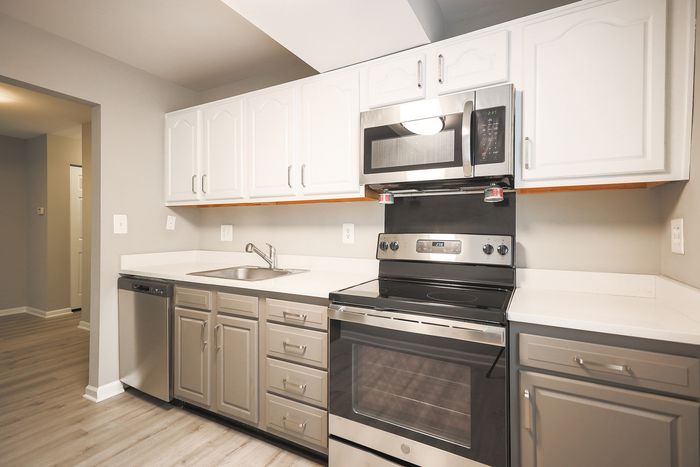 Modern kitchen at ReNew White Marsh with sleek stainless steel appliances, bright cabinetry, and elegant countertops.
