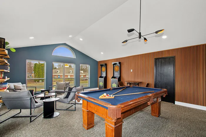 Chic game room with elegant pool table, plush seating area, and stylish dart machines, perfect for entertainment and relaxation.