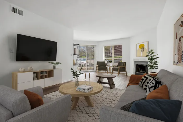 Bright and modern living room featuring sleek furniture, elegant decor, and large windows allowing natural light to flow in.