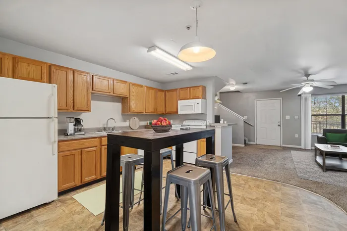Townhomes at TSC Open-Concept Kitchen with Wooden Cabinetry
