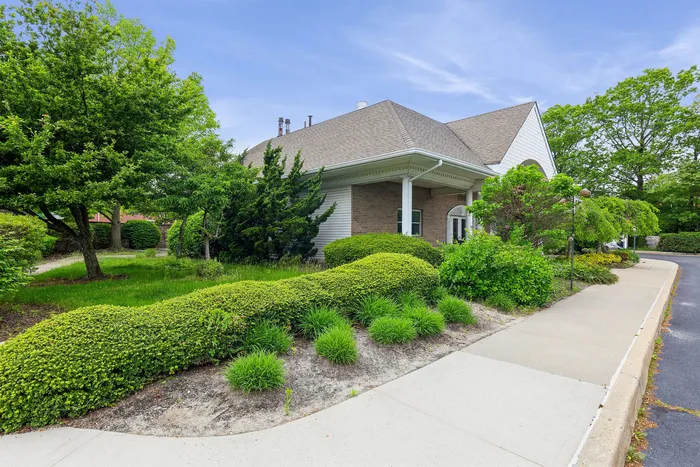 Charming suburban home with lush green landscaping and a spacious front lawn, perfect for outdoor enjoyment.