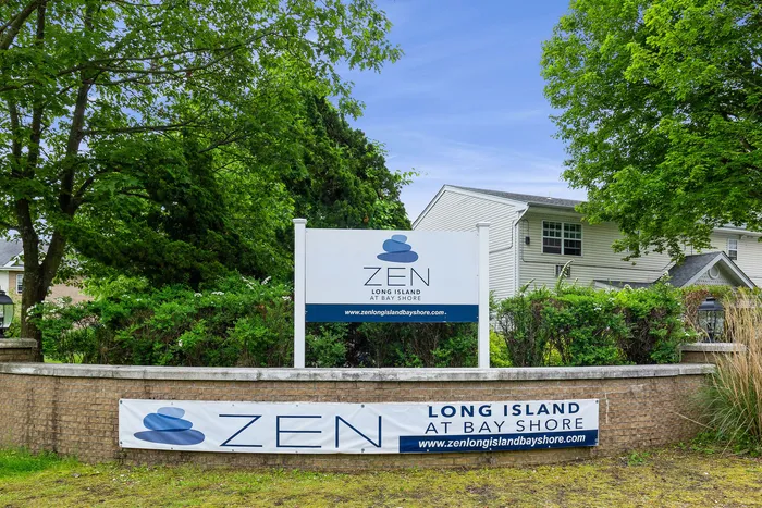 Charming entrance to Zen Long Island at Bay Shore, highlighted by lush greenery and inviting signage.