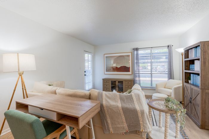 Bright and welcoming living room with cozy beige sofas, modern wood furniture, and elegant decor, perfect for relaxation and style.