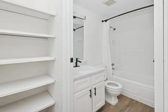 Bright and inviting bathroom with elegant fixtures, spacious shelving, and modern design, perfect for a refreshing retreat.