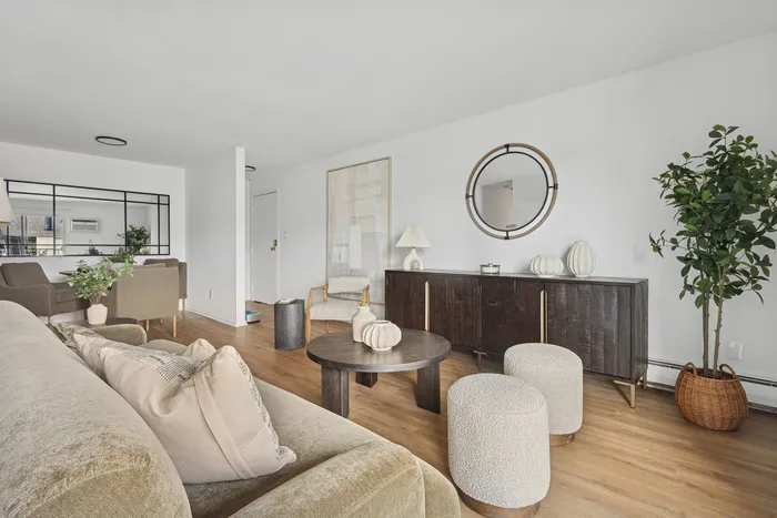 Chic living room featuring elegant decor, plush seating, stylish coffee table, and modern accents, all set on beautiful hardwood flooring.