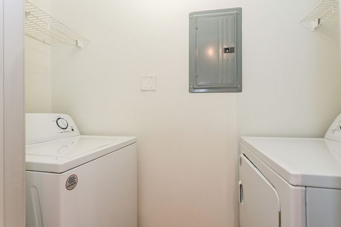 Bright and efficient laundry room with modern washer and dryer, perfect for convenient in-home cleaning.