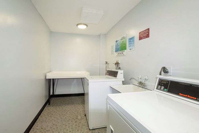 Bright, clean laundry room featuring modern appliances and ample workspace.