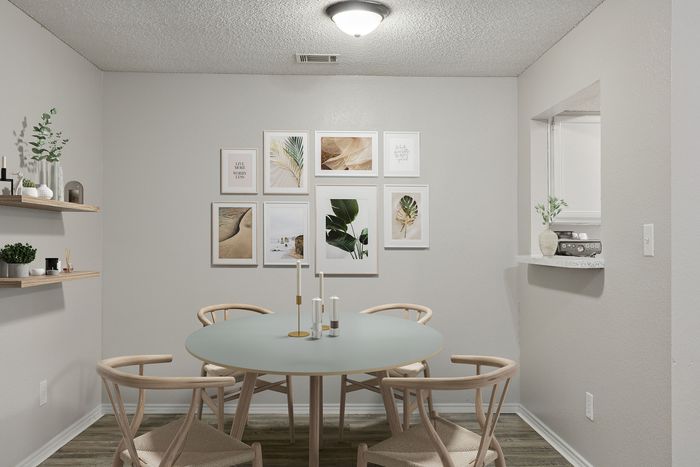 Chic dining area with a modern round table, elegant chairs, and stylish wall art, perfect for cozy dinners.