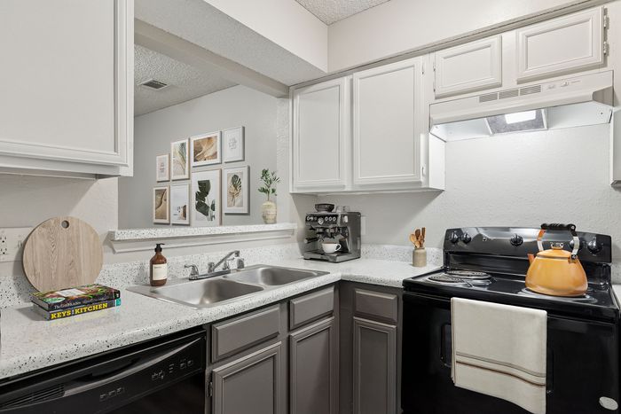 Bright and modern kitchen with sleek countertops, stylish cabinetry, and a cozy coffee corner.