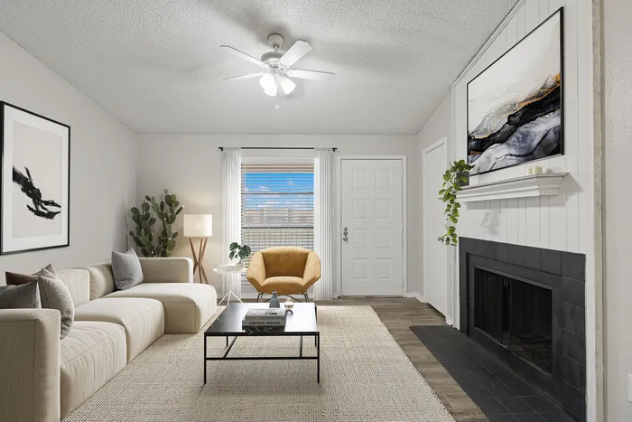 Bright and inviting living room with a cozy beige sofa, chic decor, and a modern fireplace.