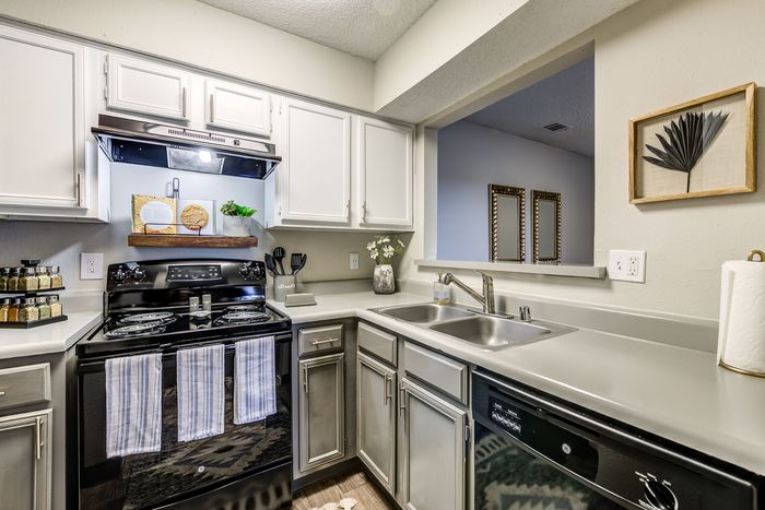 Charming kitchen with sleek countertops, modern appliances, and stylish cabinetry, perfect for cooking enthusiasts.