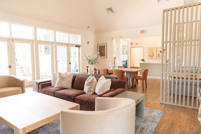 Inviting living area at ReNew Howard Crossing with modern seating, natural light, and elegant decor, perfect for relaxation and social gatherings.