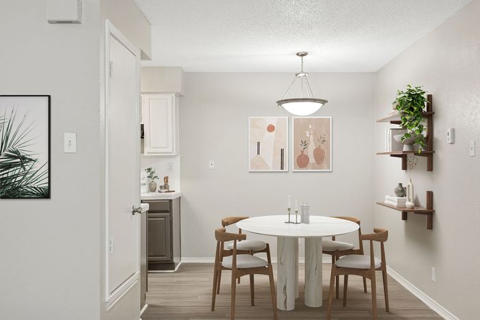 Modern dining area with elegant round table, stylish wooden chairs, and chic wall art, accentuated by soft light and lush greenery on floating shelves.