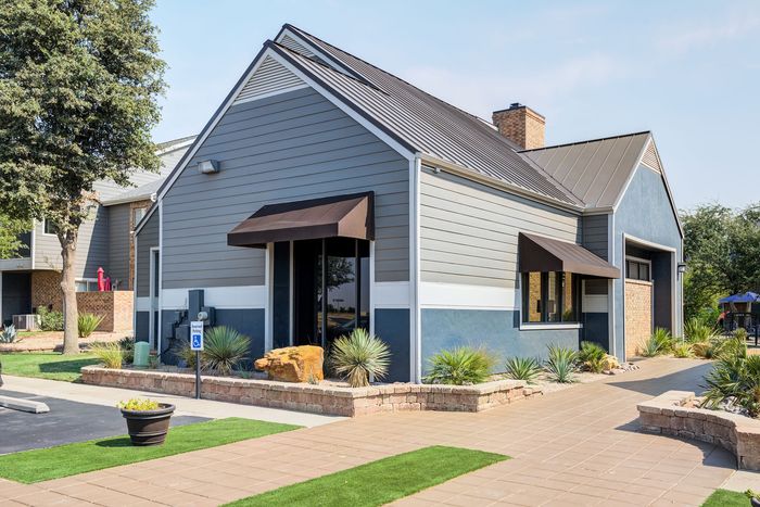 Charming contemporary building with modern design, featuring stylish awnings and well-maintained landscaping, creating an inviting atmosphere.