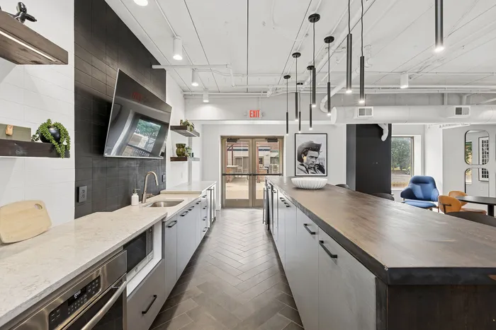 Modern kitchen with sleek countertops, stylish pendant lighting, and an inviting open layout perfect for entertaining.