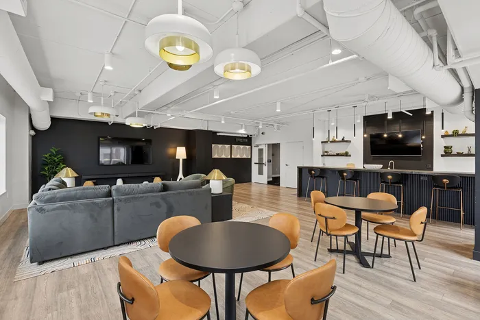 Modern apartment interior featuring a sleek, open-plan living and kitchen area with stylish lighting, elegant seating, and contemporary decor.