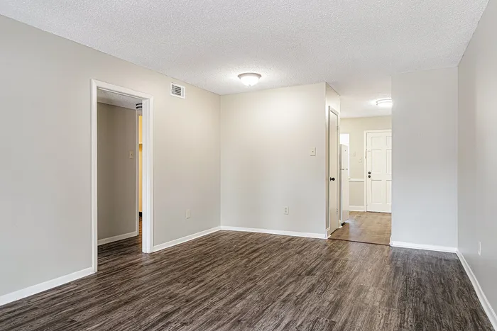 Bright apartment interior featuring elegant hardwood floors, spacious entryway, and modern neutral walls.
