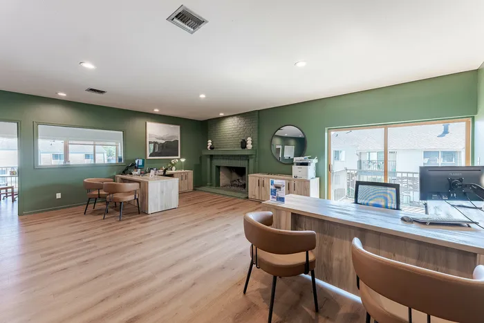 Elegant apartment interior with stylish green accents, modern wooden furniture, cozy fireplace, and ample natural light.