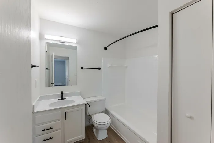 Modern bathroom with sleek white fixtures, stylish vanity, and elegant tile detailing.