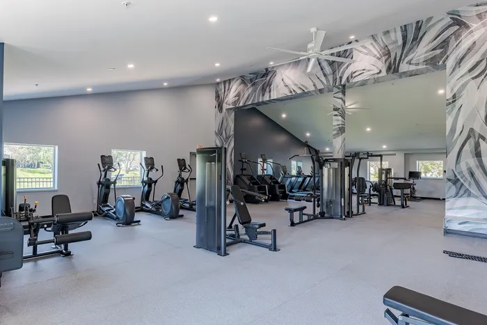 Spacious and modern fitness center with state-of-the-art workout equipment and vibrant decor.