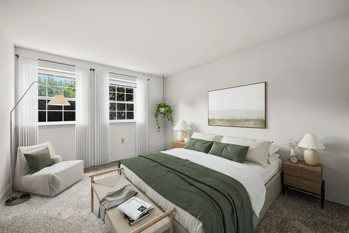 Bright and cozy bedroom with a large window, elegant decor, and lush greenery, offering a tranquil and inviting retreat.