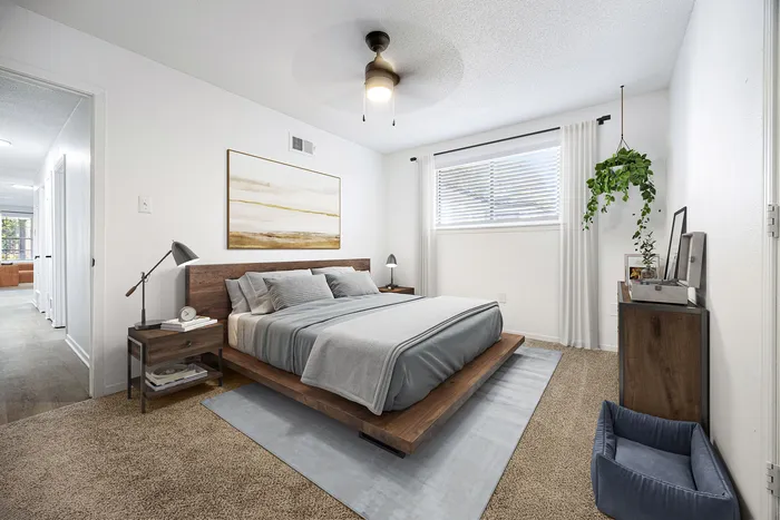 Inviting bedroom with a modern design featuring a cozy bed, sleek nightstands, and a vibrant hanging plant, bathed in natural light.