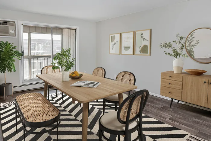 Bright dining room with stylish wooden furniture, modern decor, and large window for natural light.