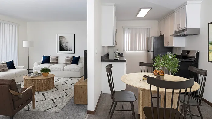 Contemporary open-concept living and dining area with cozy seating, stylish decor, and a modern kitchen.