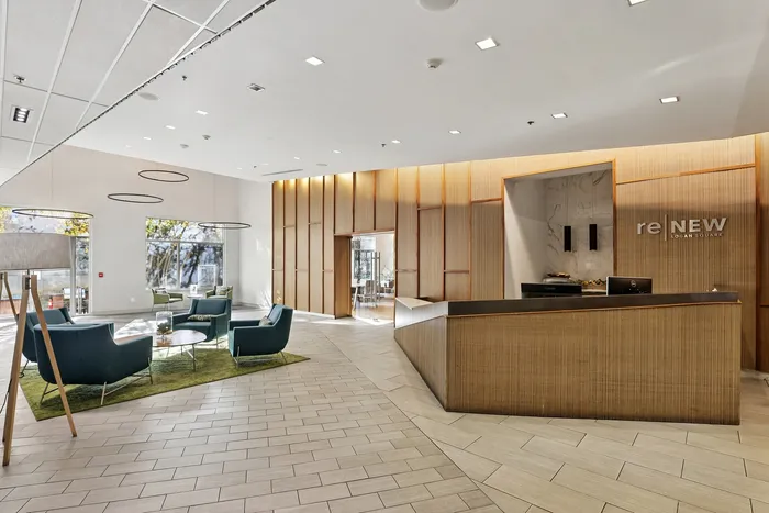 Elegant lobby with modern seating, wooden feature walls, and stylish lighting fixtures, creating a welcoming atmosphere.