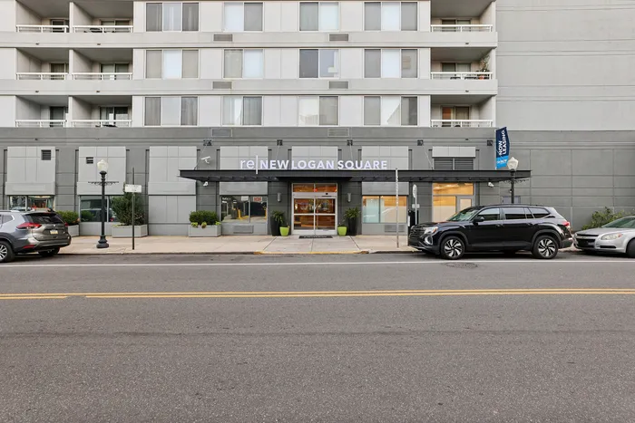 Modern apartment building exterior with stylish entrance and street view, showcasing elegance and convenience in an urban setting.