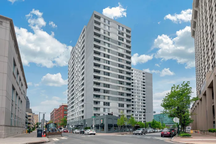 Contemporary high-rise apartment building in a vibrant city neighborhood, offering modern urban living with scenic views.