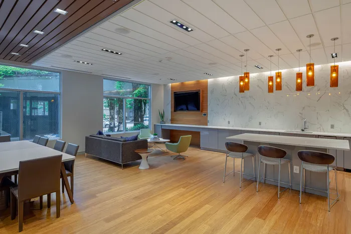Contemporary open-concept living space with chic furniture, modern kitchen island, and elegant lighting, offering a spacious and welcoming atmosphere.