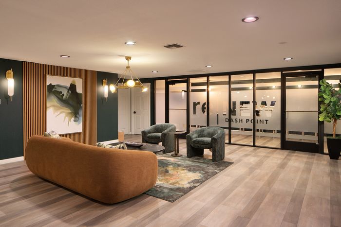 Elegant and modern lounge area with stylish lighting, plush seating, and chic decor at reNEW Dash Point.